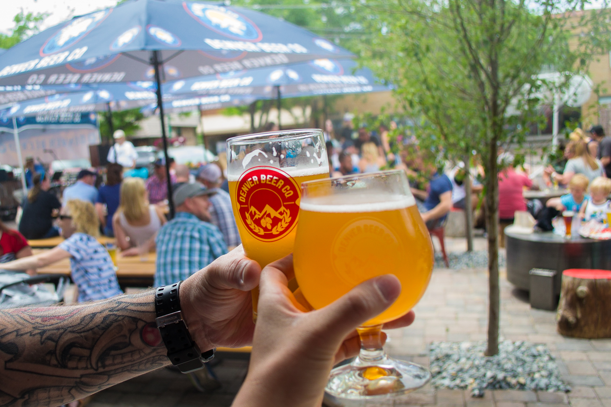 A fresh Denver Beer Co. craft beer enjoyed on the patio during a busy day in historic Olde Town Arvada.