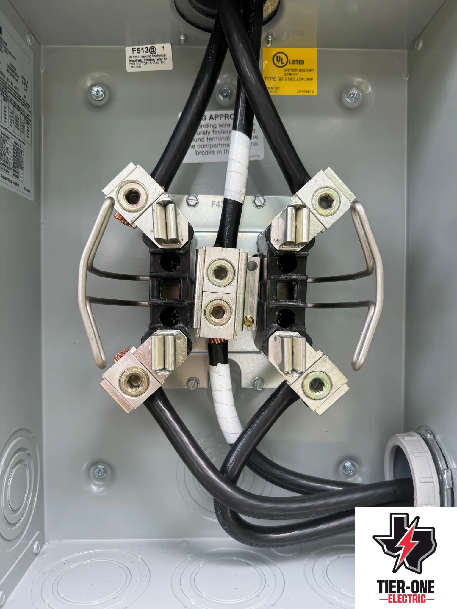 Electrical service equipment and wiring shown during a professional inspection or service by Tier One Electric.