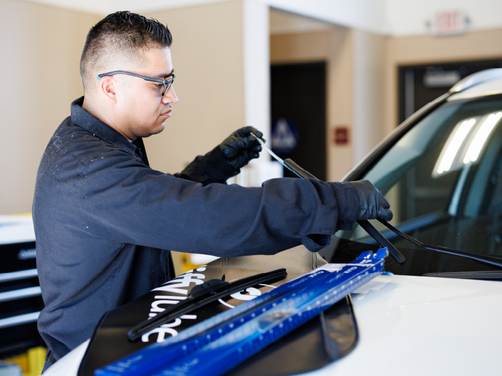 tech replacing windshiled wiper