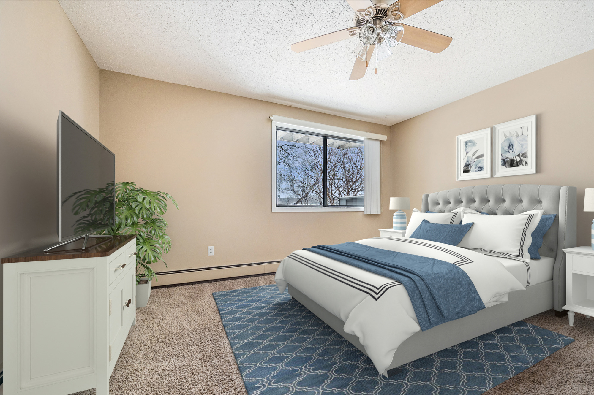 a bedroom with a large bed and a ceiling fan at Heritage Hills Apartments, Bloomington, Minnesota