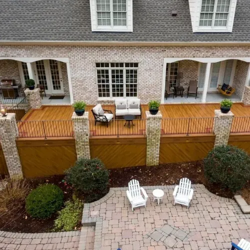 Custom deck and outdoor entertaining space in Central North Carolina with wood decking, built-in seating, and landscaped surroundings. Designed and built by an experienced outdoor living contractor serving the Badin Lake area.
