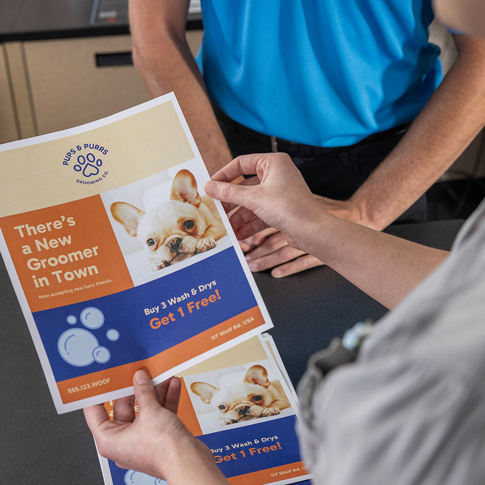 UPS Store Associate Printing flyers for customer