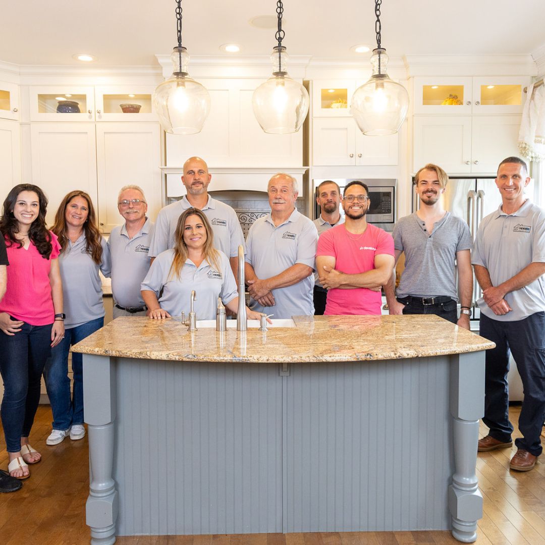 The Fiderio & Sons team stands together inside a beautifully remodeled kitchen.