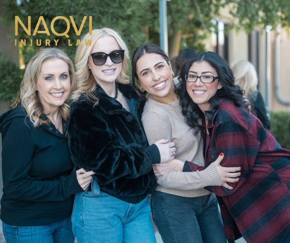 Naqvi Law team hugging for photo