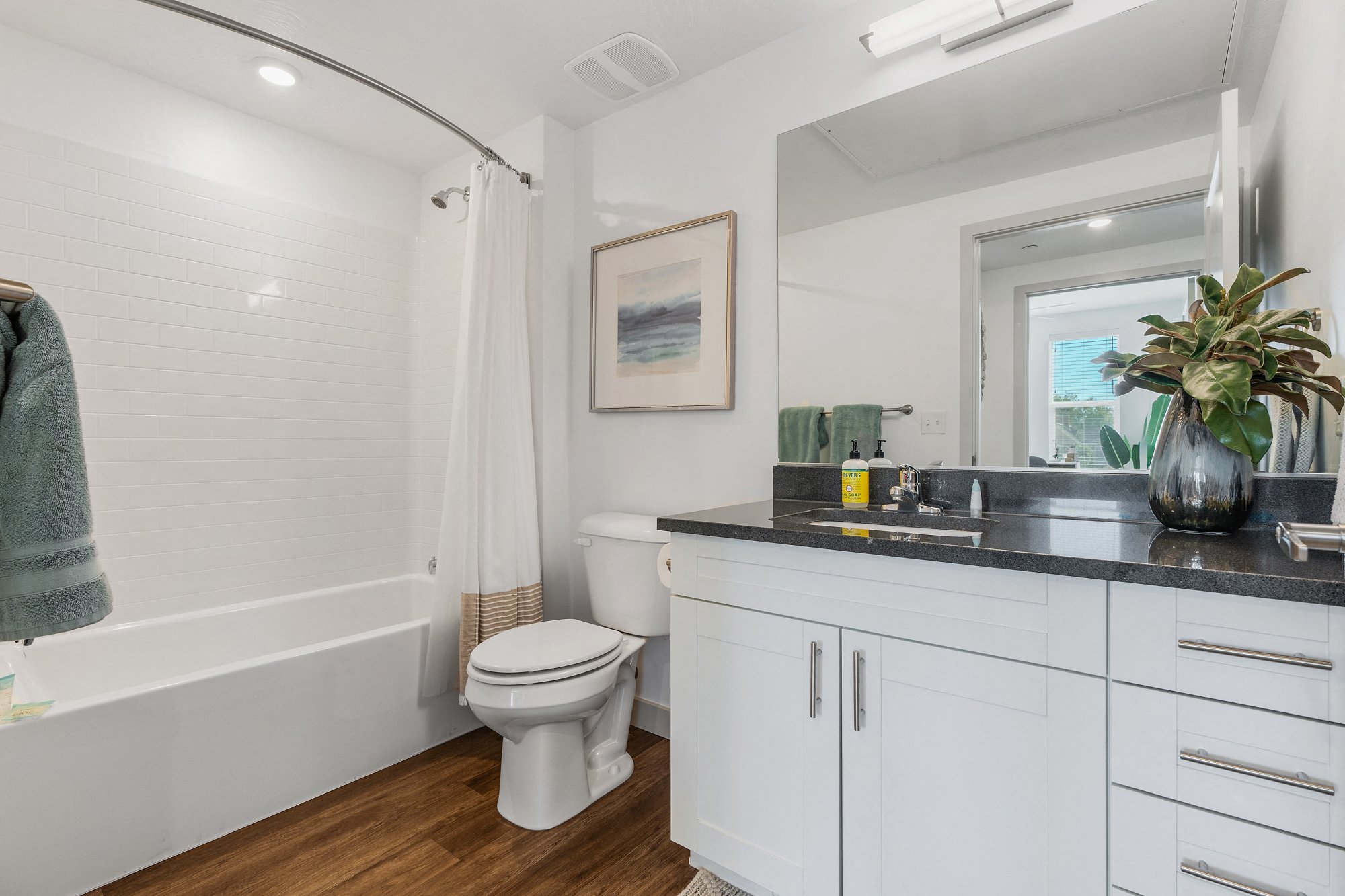 a bathroom with a toilet and a sink and a mirror