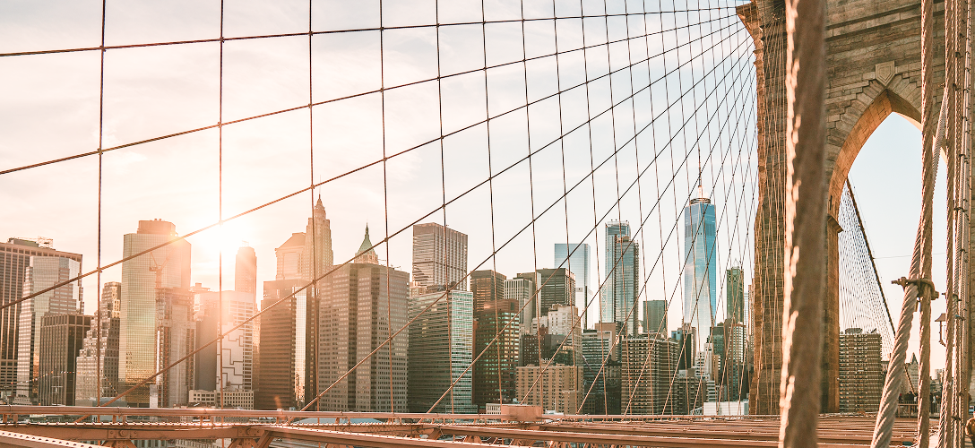 The New York City skyline, pictured through the cables of the Brooklyn Bridge.
