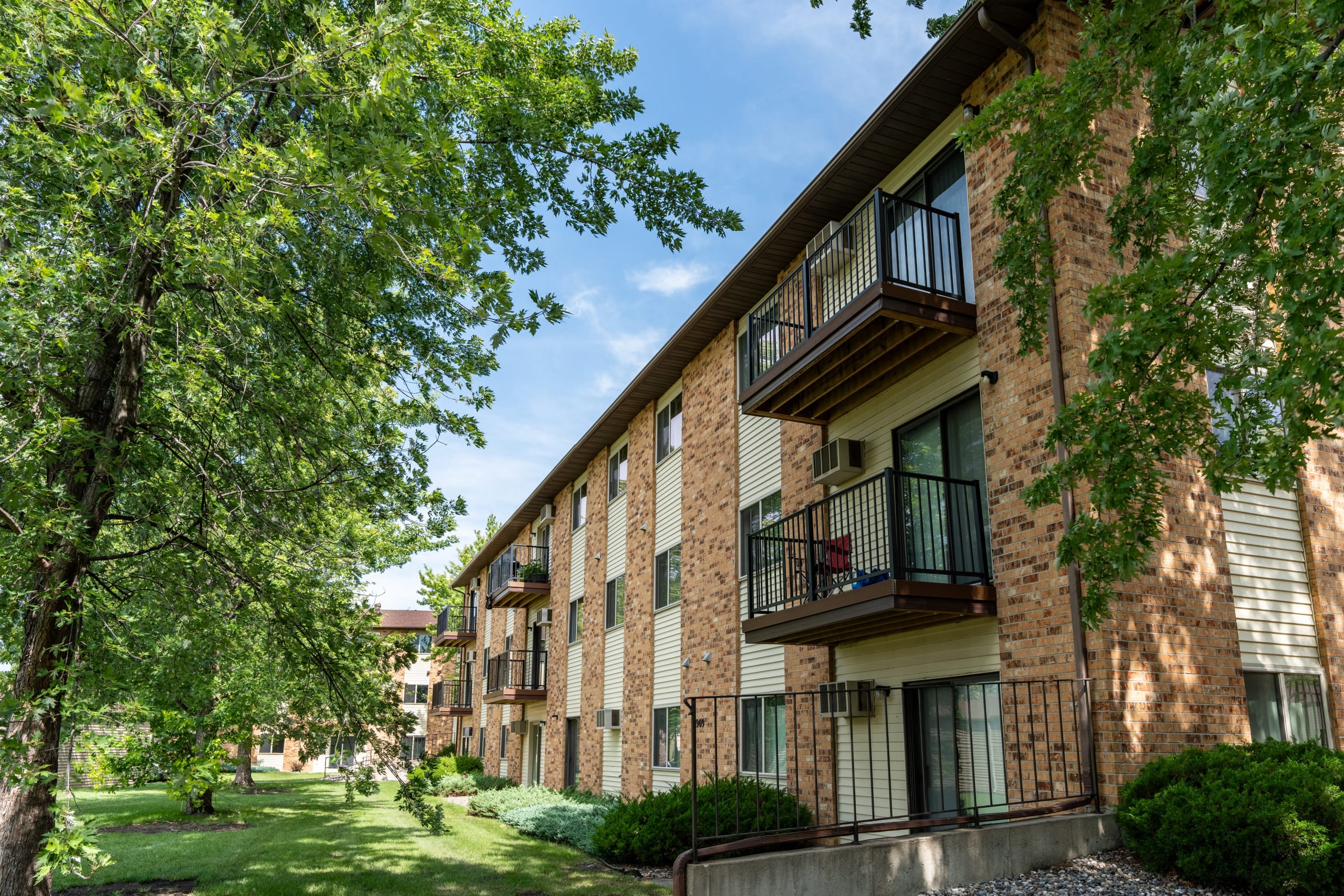 Exterior view of a brick apartment building with balconies