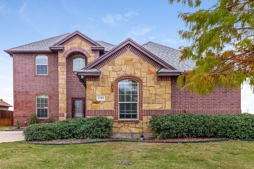 Charming home with brick and stone at Invitation Home Dallas.