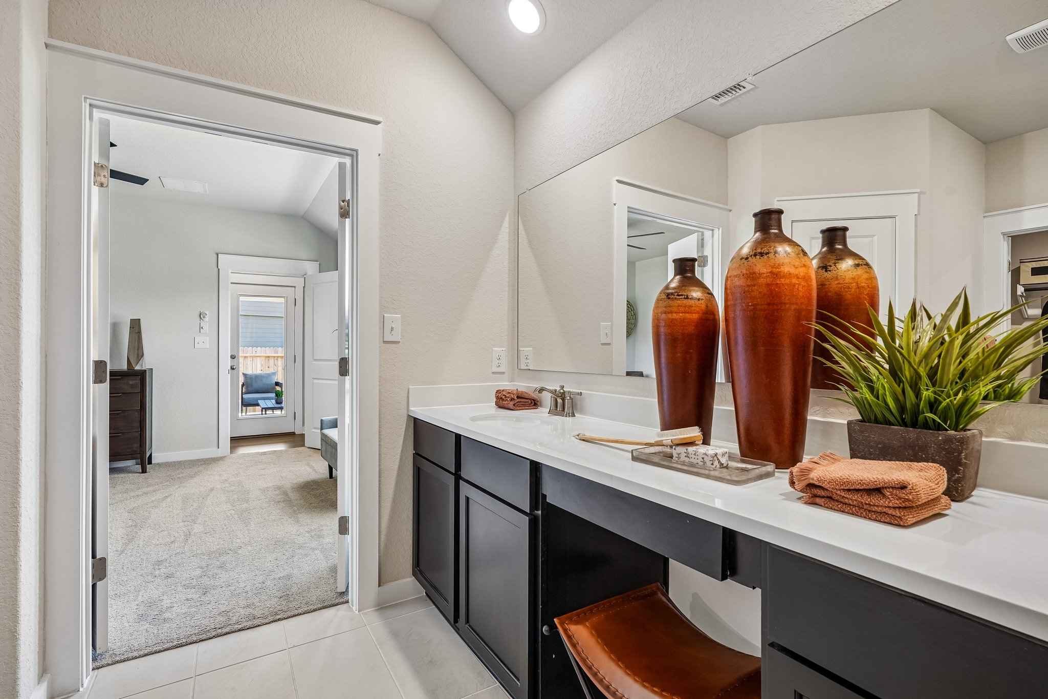 Owner’s Suite Vanity Area with Dedicated Space for Seating and Getting Ready 