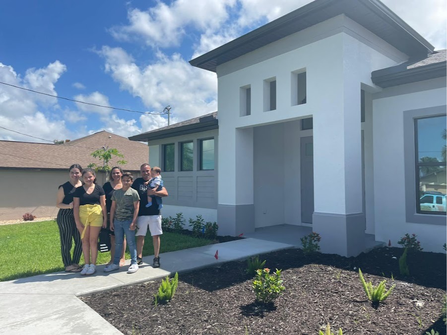 Happy Customers Celebrating Outside Their South Florida Home After Closing with 1st Florida Mortgage 