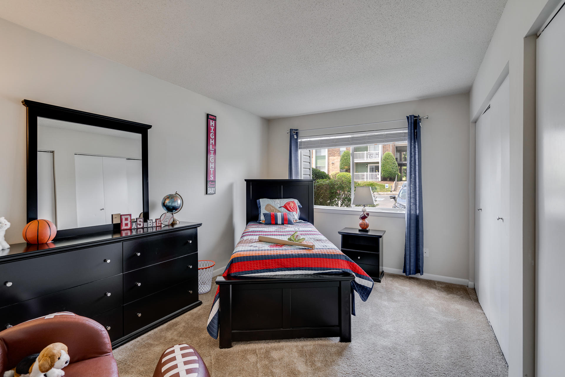 Bedroom With Plush Carpet & Large Windows