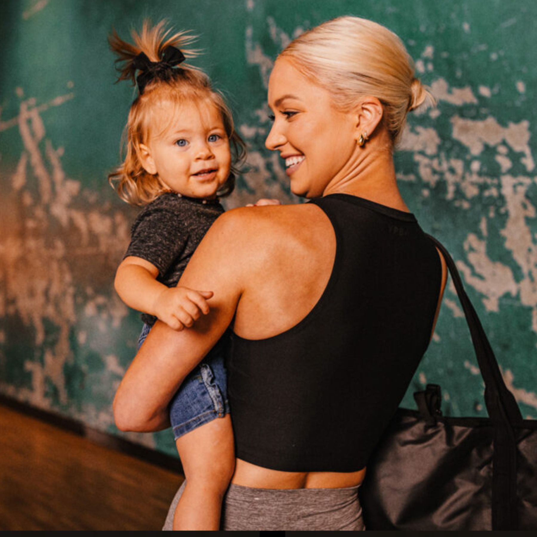 A member arrives at our Cheyenne gym carrying her young child before starting her workout. With convenient onsite childcare services, parents can focus on their fitness while their little ones are cared for in a safe, welcoming environment.