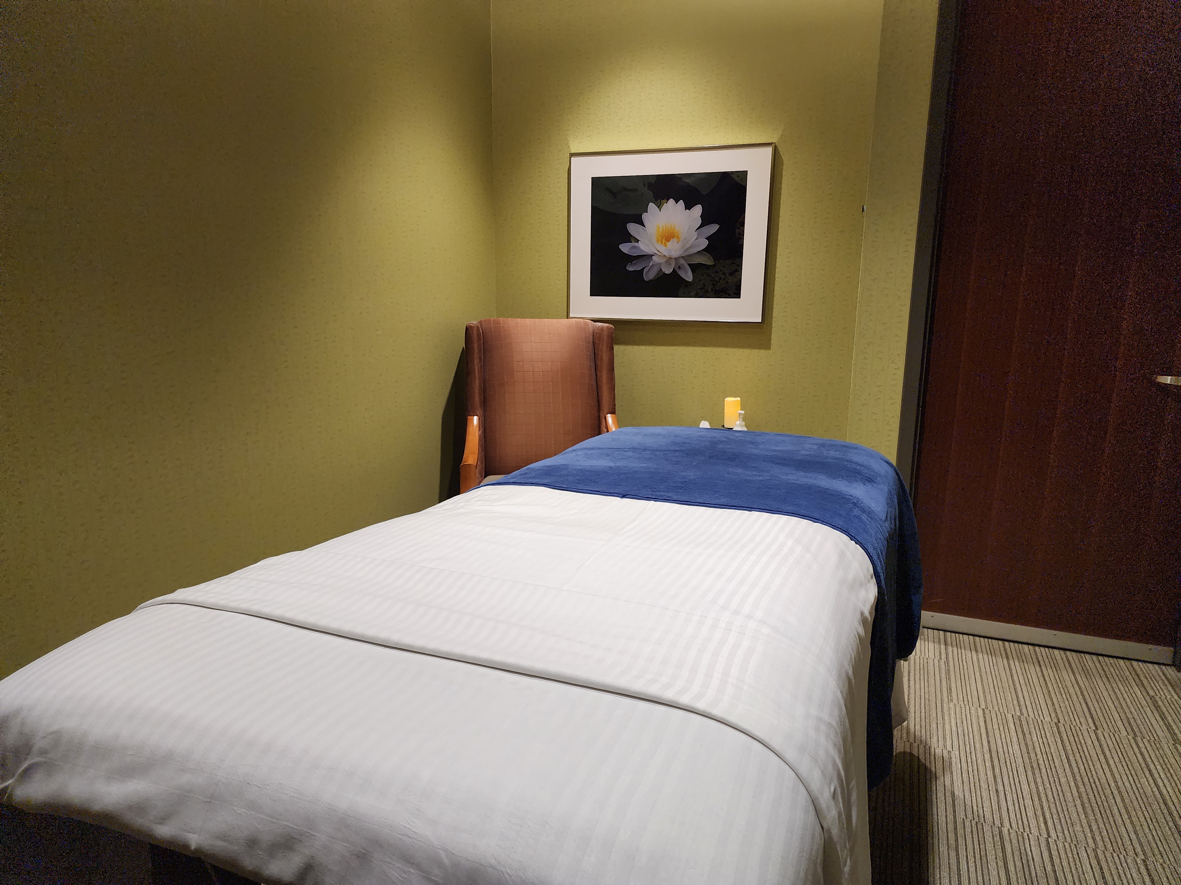 Private treatment room with massage table and calming decor