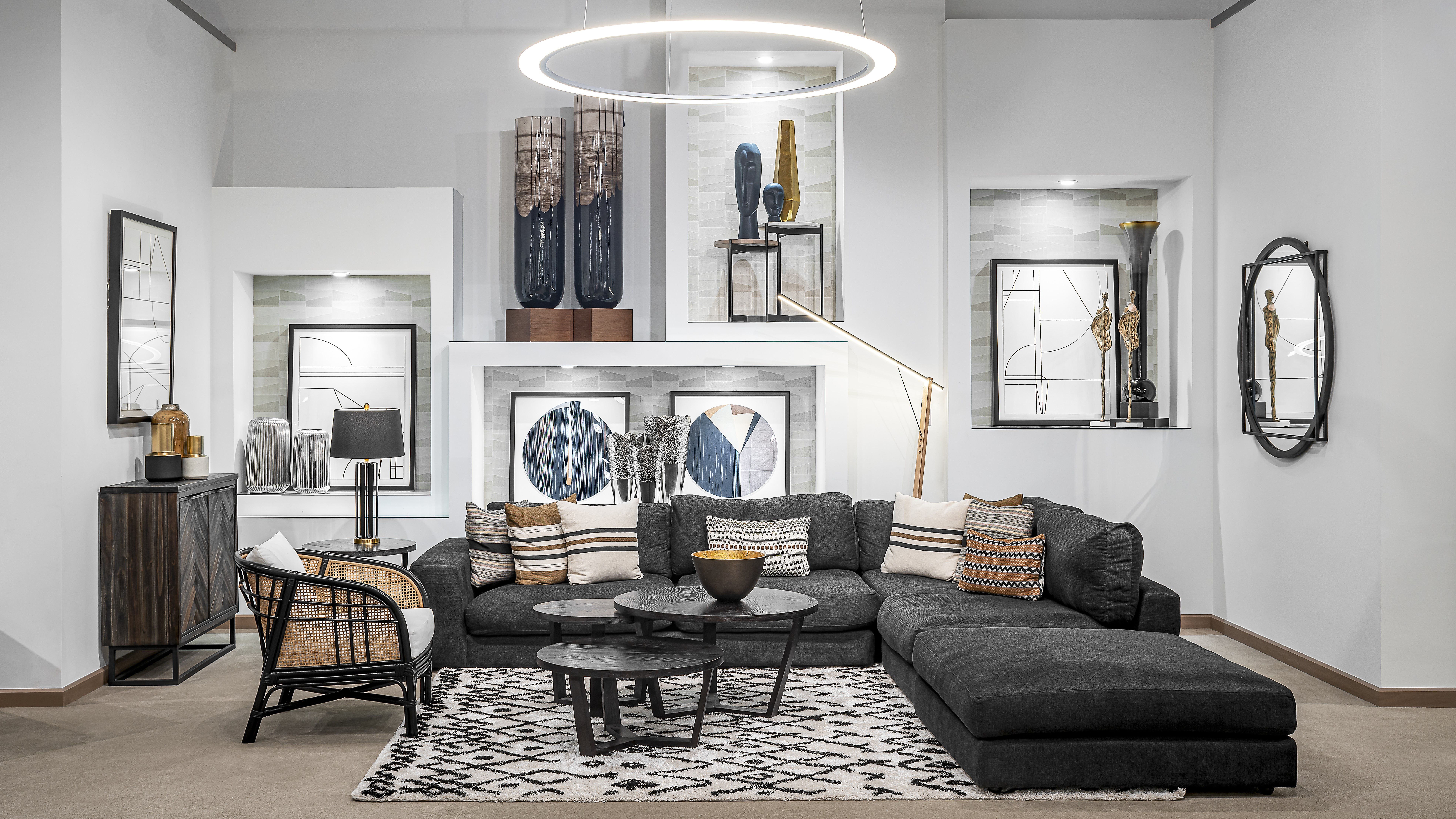 Modern living room setup with a dark sectional sofa and bold decor.