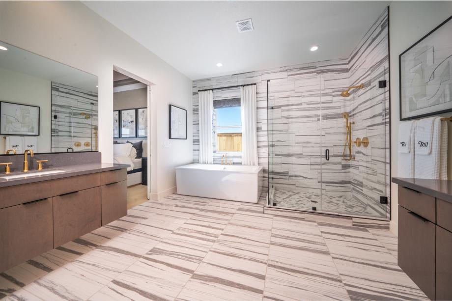 Spa-like primary bathrooms with large walk-in showers, free-standing bathtub, and dual vanities with undermount sinks