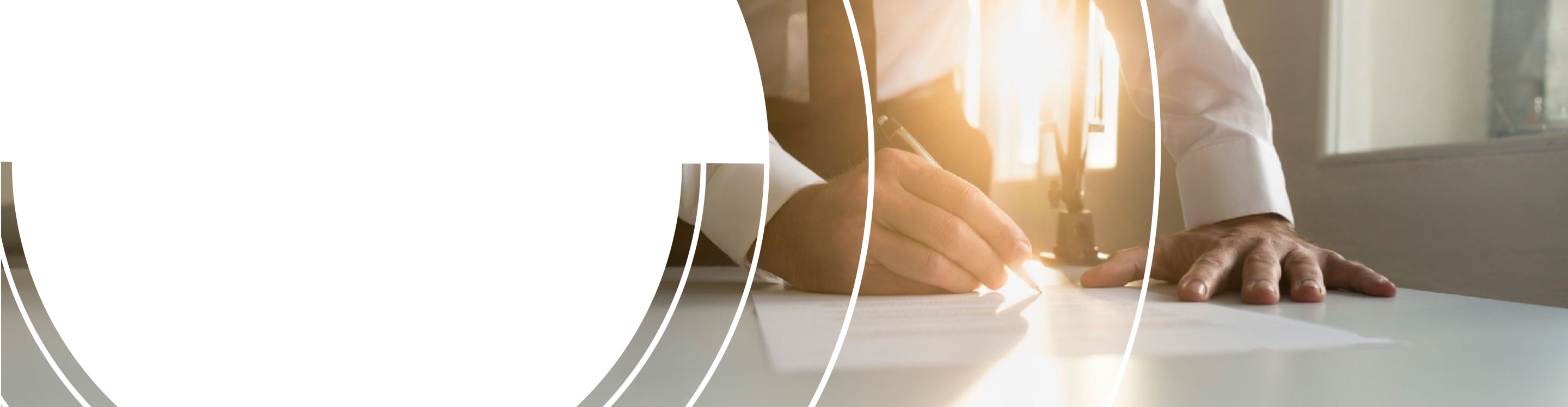 Close up of a wealth professional editing a document with the setting sun shining through the window.