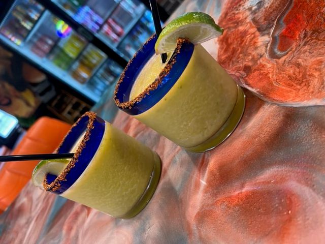 Refreshing frozen lime margaritas served with a chili-lime Tajín rim and fresh lime garnish at Catramex Restaurant in Saco, Maine. Handcrafted cocktails made to pair perfectly with authentic Mexican and Honduran cuisine.