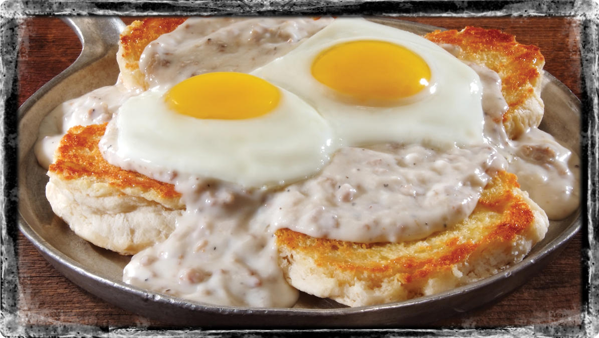 Southern Tradition - Two grilled biscuits topped with sausage gravy and two fresh eggs* cooked any s Iron Skillet McCalla (205)477-9178