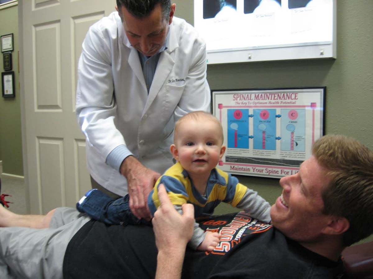 Dr. Pontious performing adjustment on a baby.