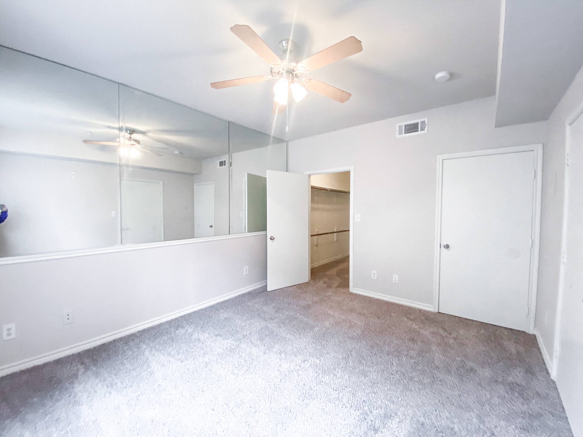 Carpeted bedroom with white walls