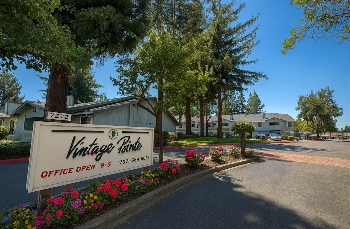 A sign for Vintage Pointe with an office open sign and a phone number.