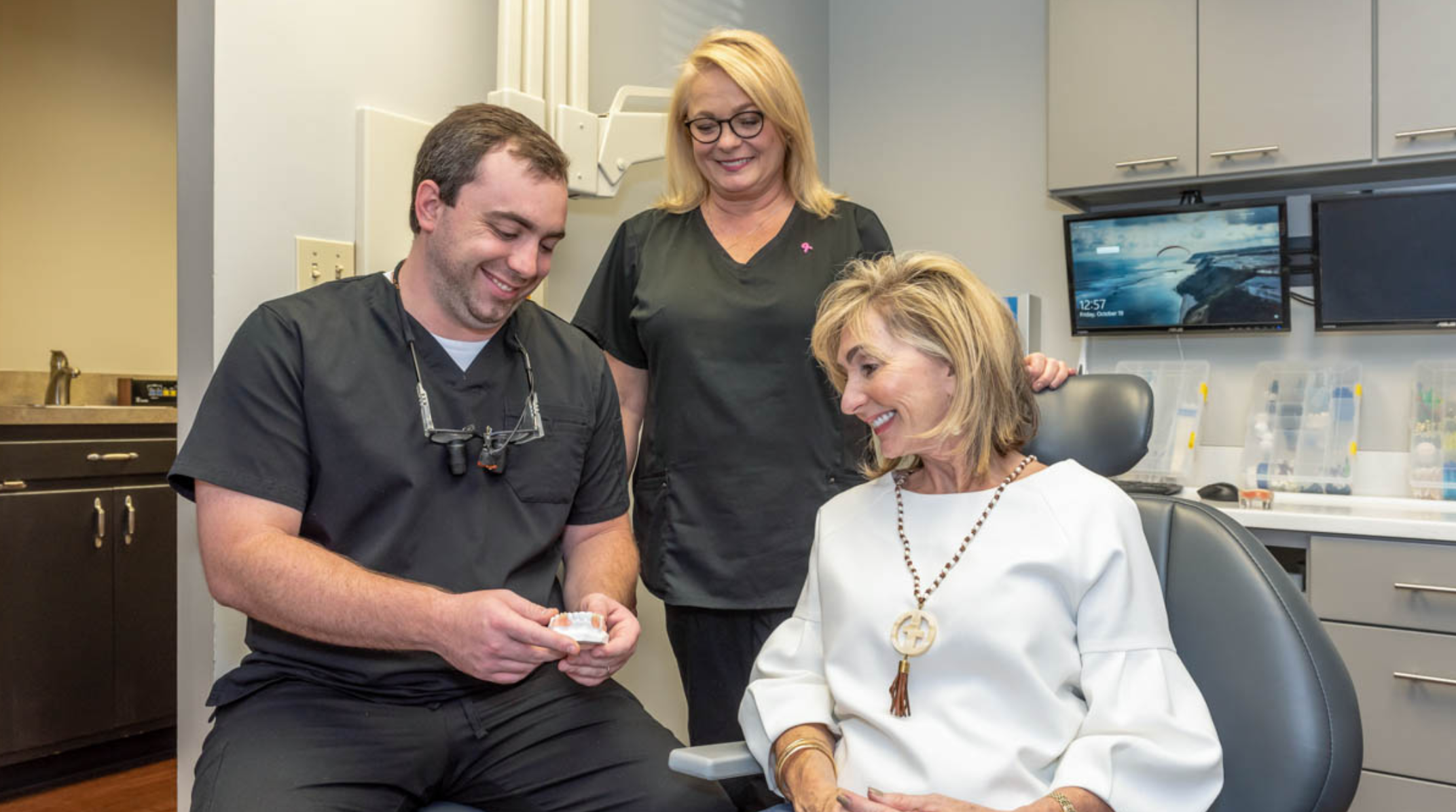 Personalized patient care at Hill Family Dental Columbia with dentist and team discussing treatment options.