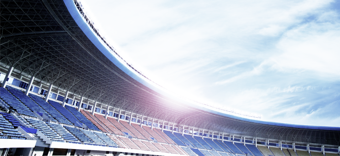 An open roof stadium on a partly cloudy day.
