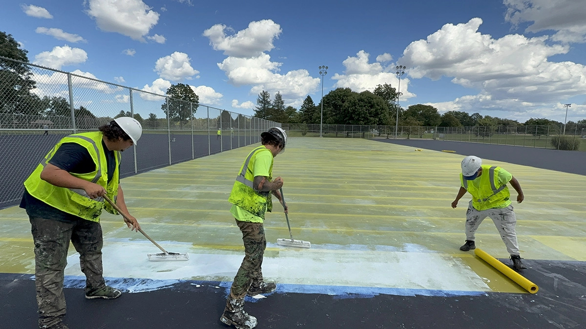 PLM crew working on an athletic court surface painting job.