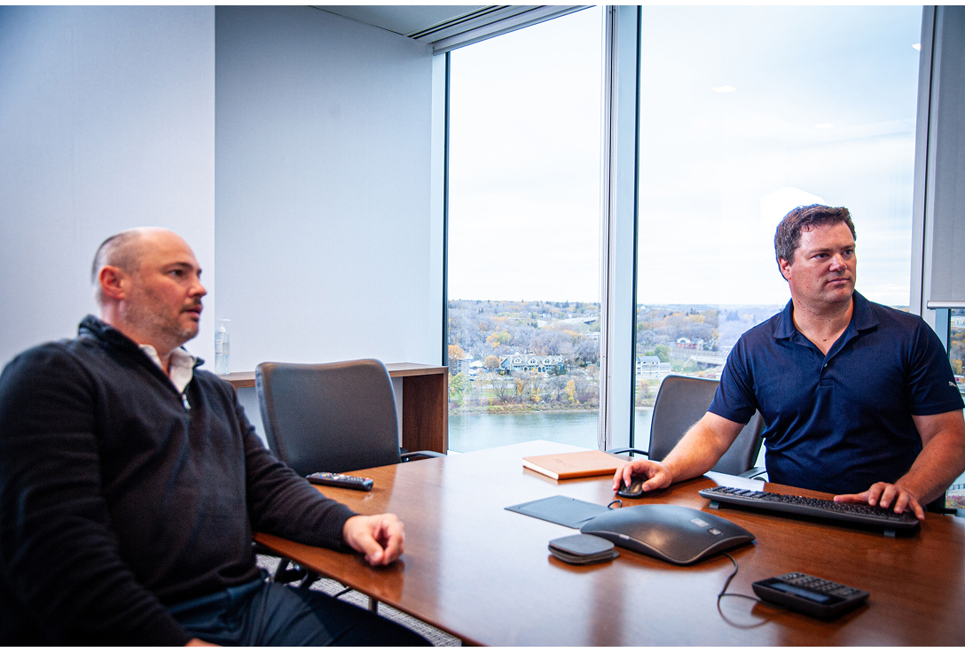 team photo sitting at office desk