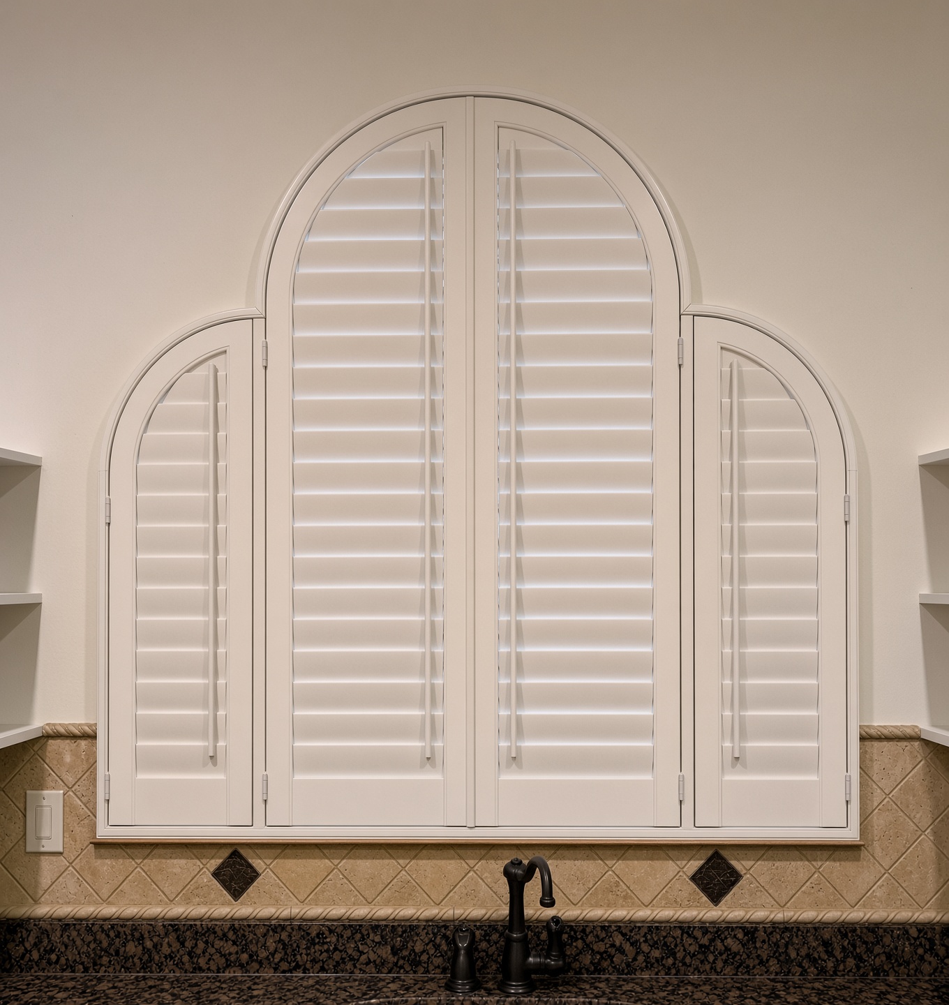 Real-wood arched plantation shutter, custom-fit over a Mobile, AL kitchen sink.