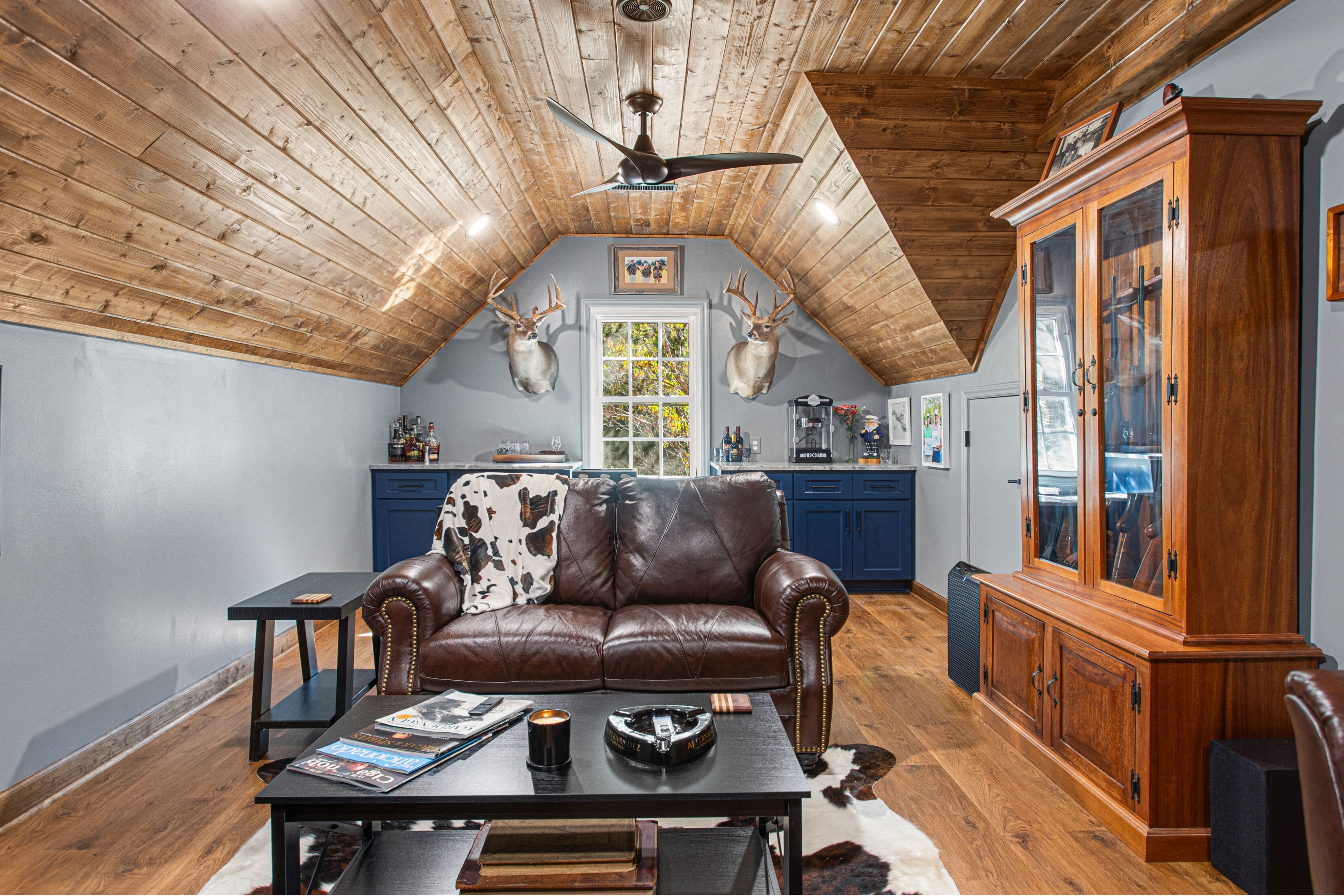 Custom finished living space near Badin Lake, North Carolina featuring a stained wood ceiling, built-in cabinetry, and custom trim work. This interior renovation highlights expert craftsmanship and high-quality residential remodeling by a professional general contractor.