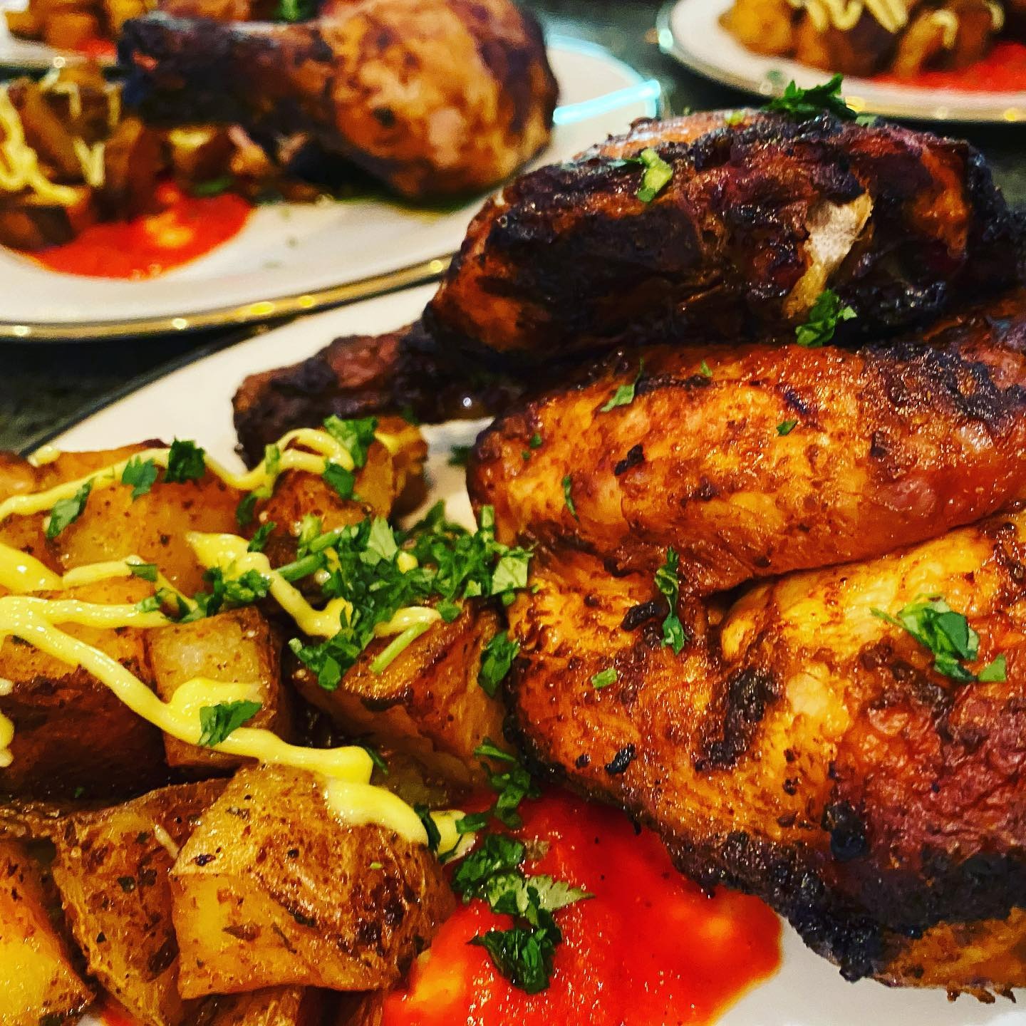 A mouthwatering plate prepared by Chef Joe, featuring perfectly roasted chicken, seasoned and grilled to a golden-brown finish, served alongside crispy herb-roasted potatoes drizzled with a light mustard aioli. Garnished with fresh herbs and paired with a vibrant red sauce, this dish showcases Chef Joe's signature balance of bold flavors, artful presentation, and chef-crafted comfort food. A perfect example of the elevated yet approachable dishes offered through his personal chef and catering services in Phoenix, Arizona.