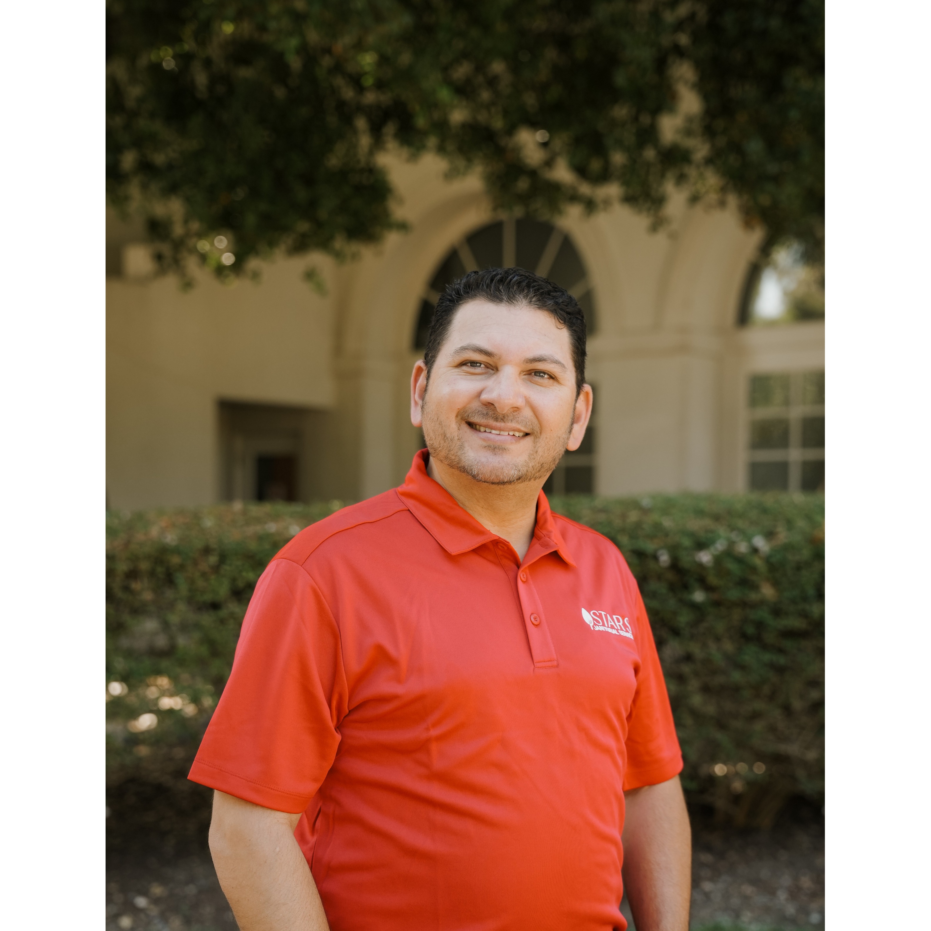 A member of the Star's Janitorial Services team in a branded red company shirt, ready to serve commercial clients across Concord and Contra Costa County.