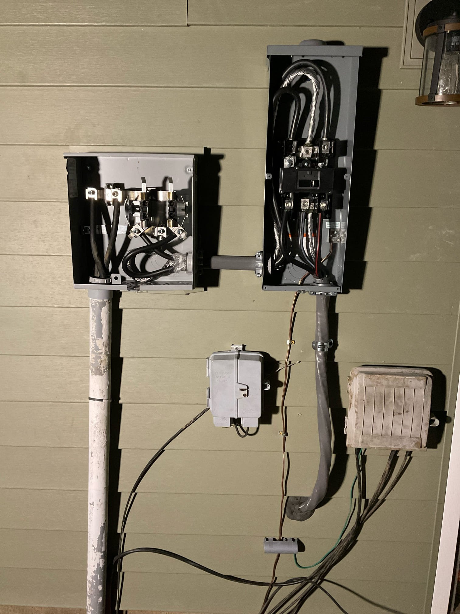 Thomas Edison Electric wired a meter base and main disconnect on the exterior of a Reading, PA home. The side-by-side configuration connects the utility service entrance to the main breaker, with a phone line junction box mounted below.