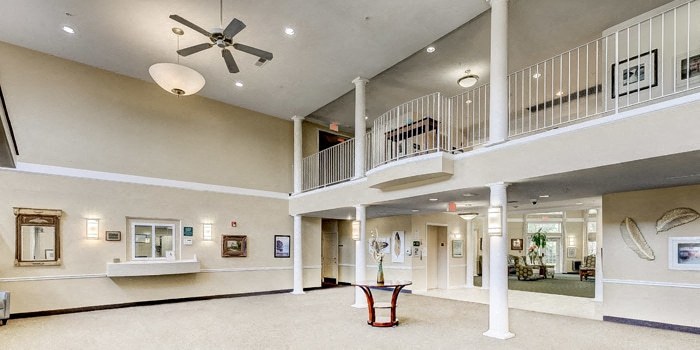 a large lobby with a ceiling fan and a balcony