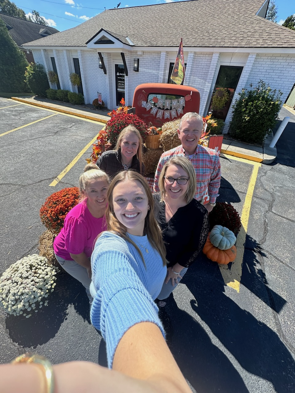 Andy Thoma's - State Farm Insurance Agent and team with fall decor on vintage truck