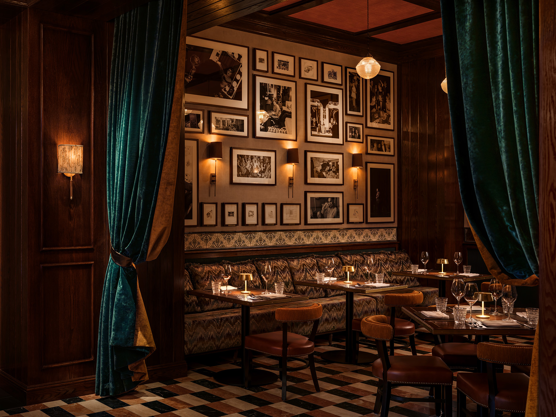 Luxury booth seating with a gallery wall of vintage photos at Carversteak NYC.