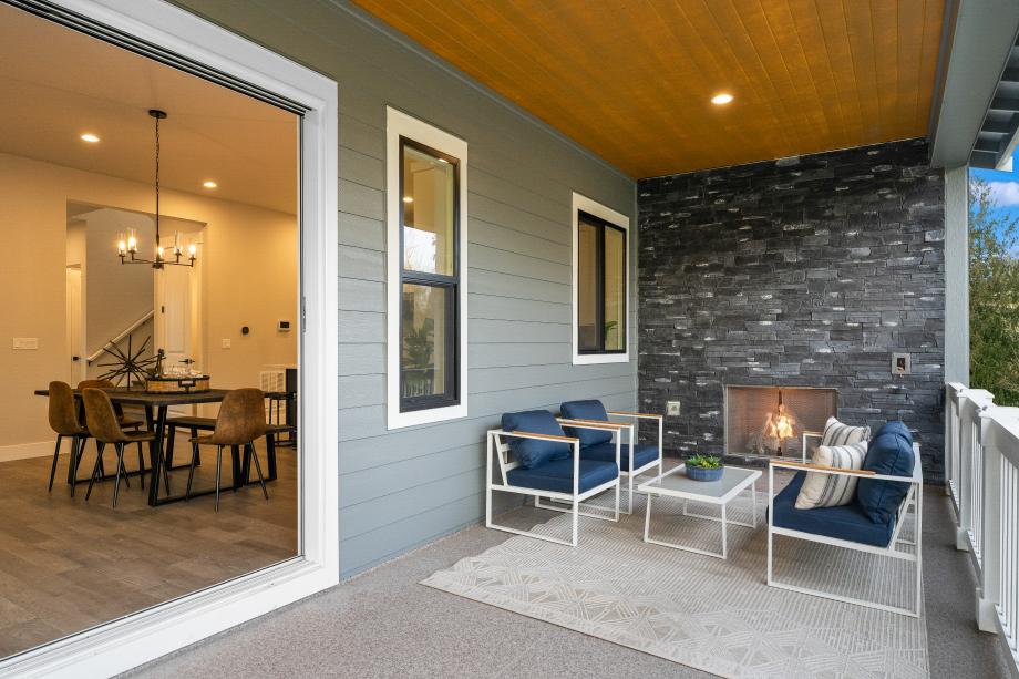 Relax on the covered patio year-round with a cozy gas fireplace
