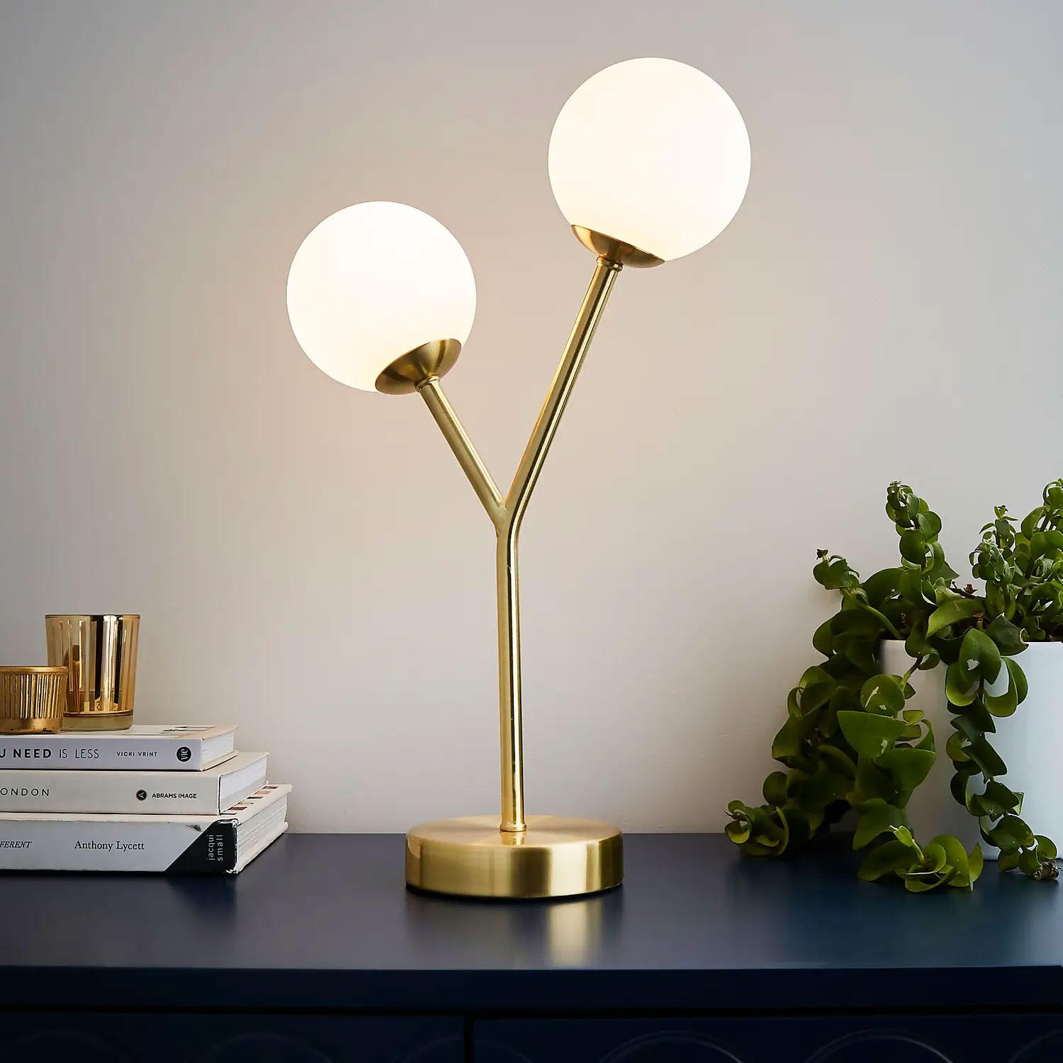 A brass and white round globe table lamp