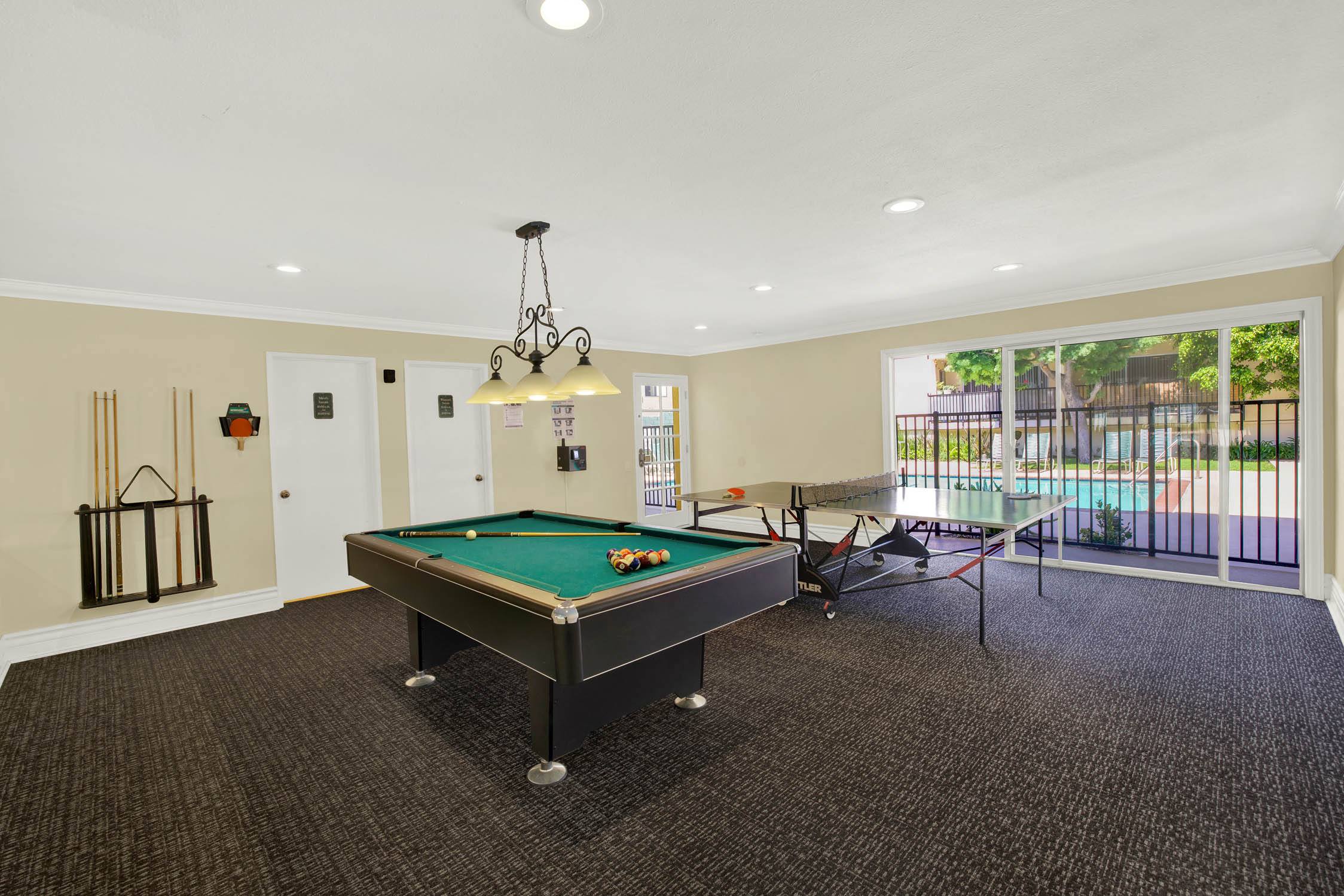 a game room with a pool table and a ping pong table