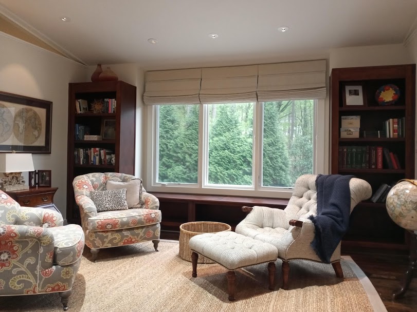 Here we installed Phase II Roman Shades with room darkening liner for this sitting area of a guest bedroom. Our Design Consultant directed that the shades be taken all the way to the ceiling so as to match drapery on the other side of the room as well as to create the illusion that the windows are t