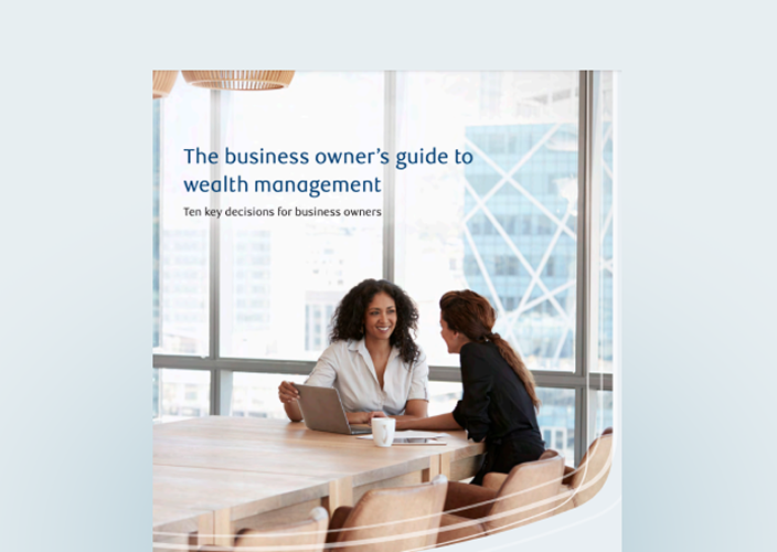 Cover of the business owner's guide with two professionals at a board room table.
