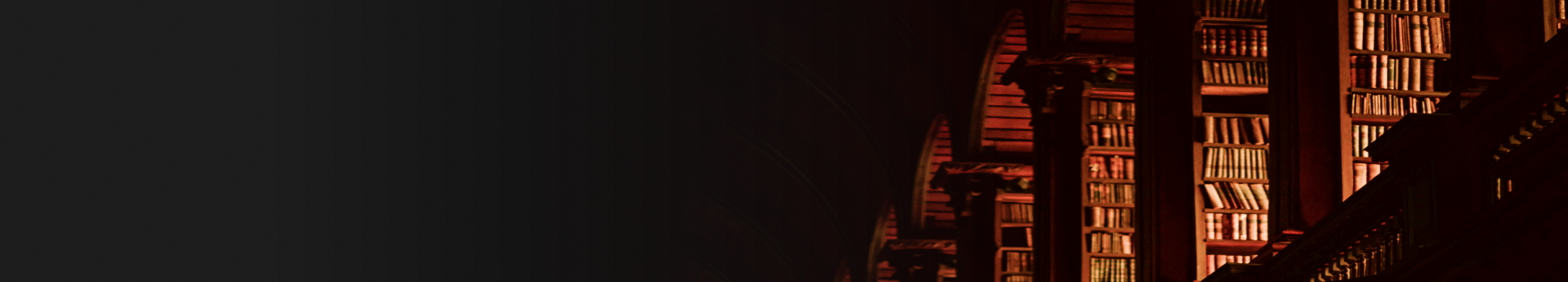 Interior shot of a traditional library with the leatherbound books in the light of the setting sun.