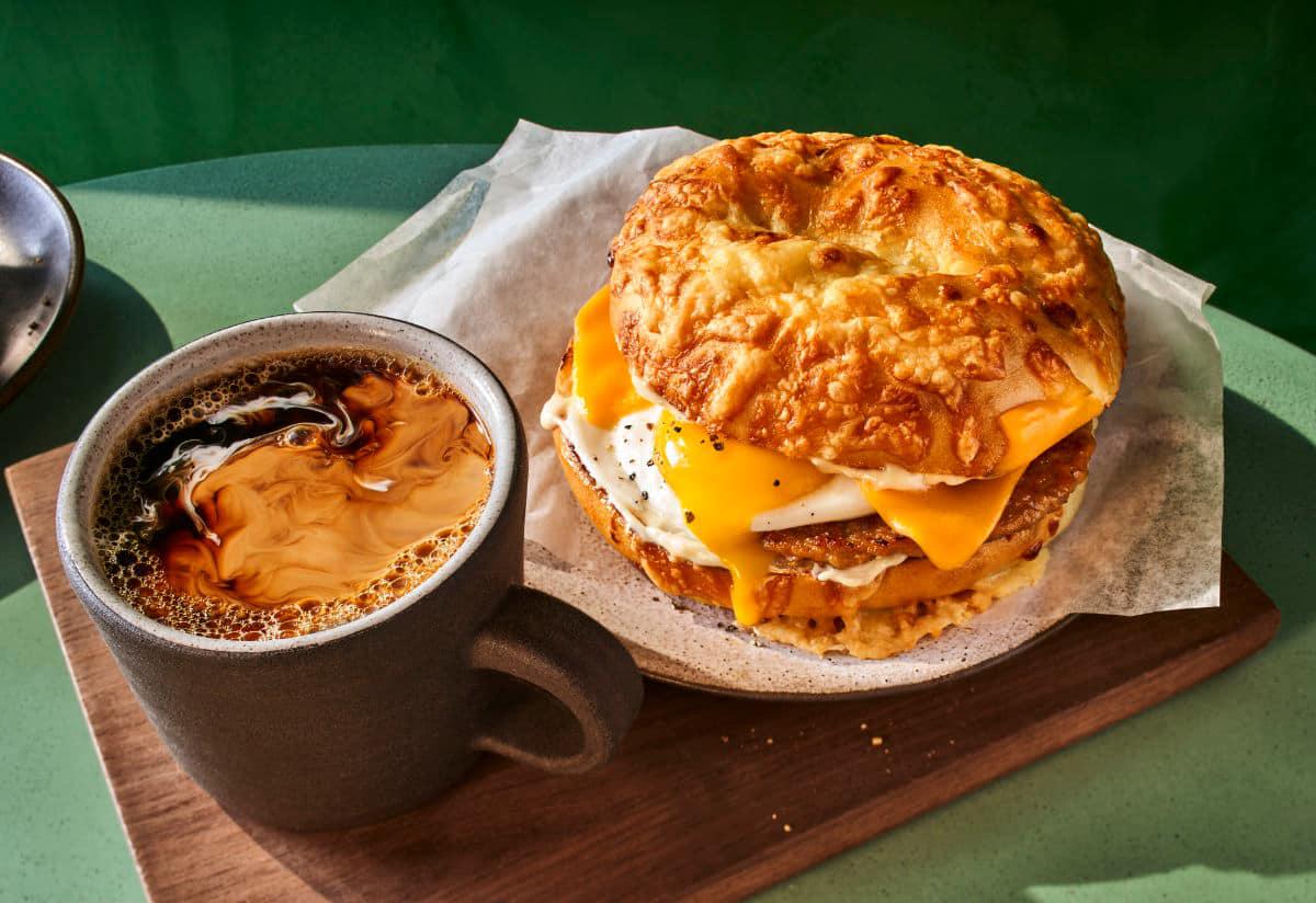 Sausage Over Easy Egg Asiago Sandwich with a hot coffee from Panera
