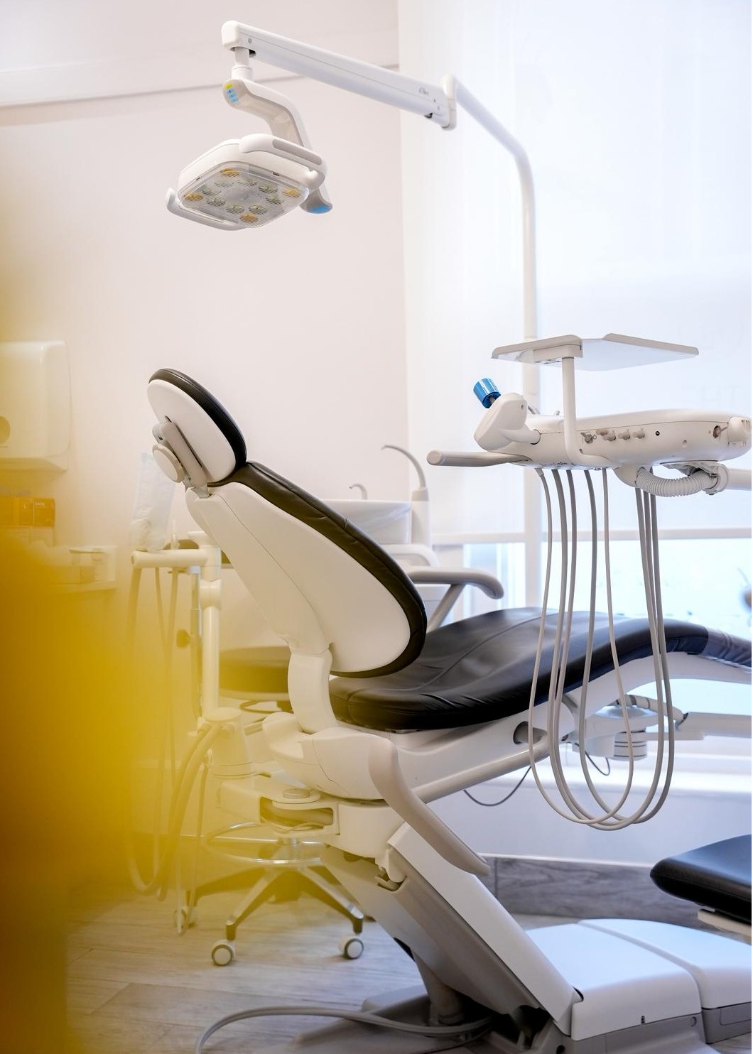 Modern dental treatment chair with overhead LED light and dental instruments inside a bright, clean treatment room at The Harrogate Clinic, Harrogate's leading private dentist.