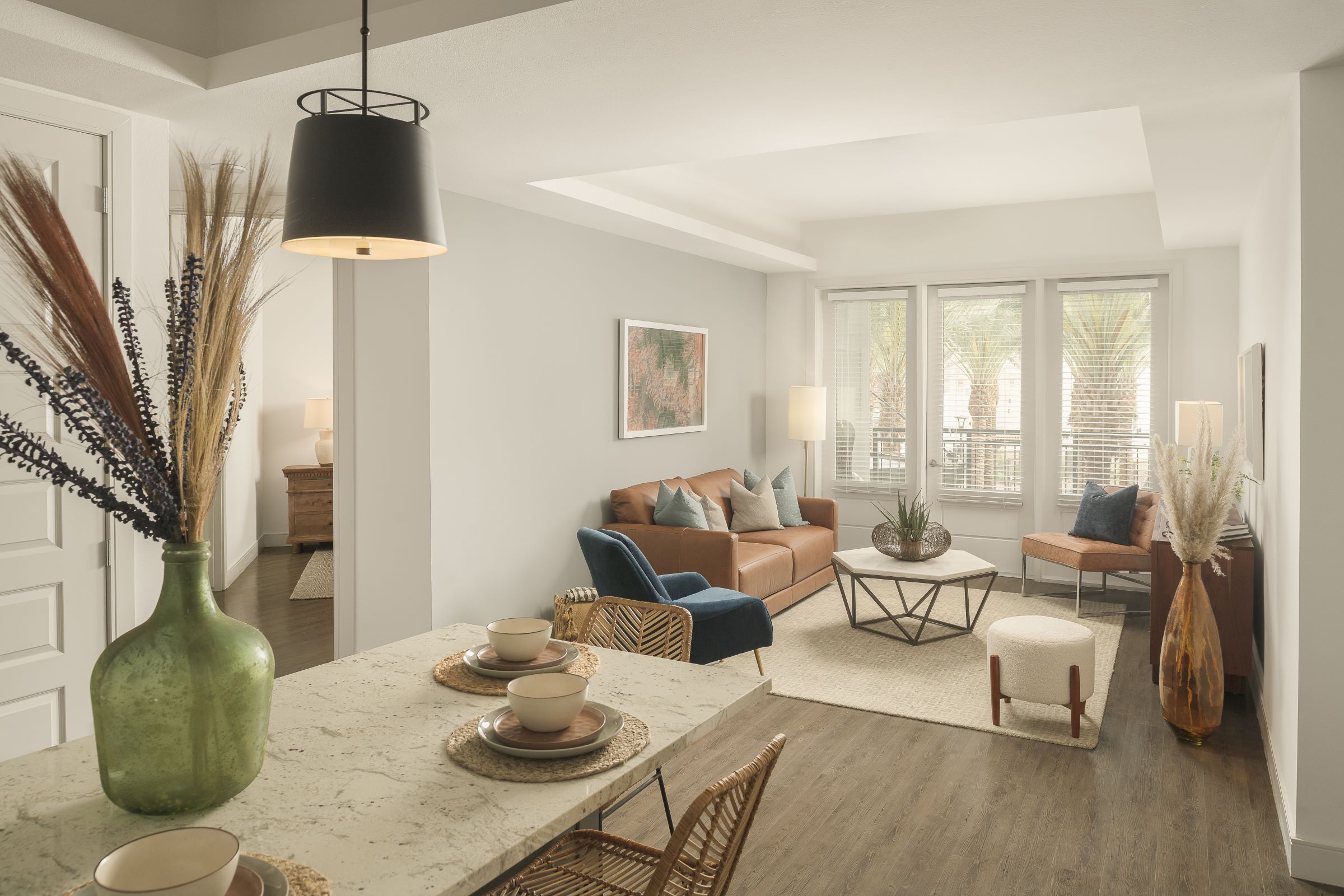 Kitchen and living room with wood-look floors at Camden Gilbert apartments in Gilbert, AZ