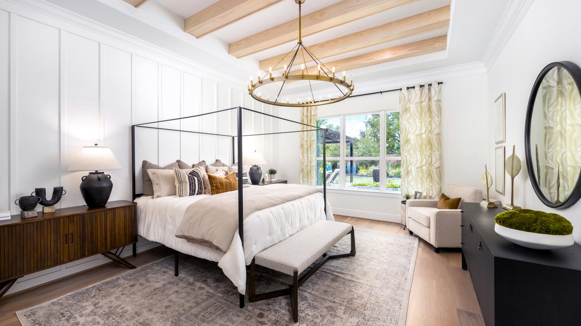 Spacious primary bedroom retreat with backyard views