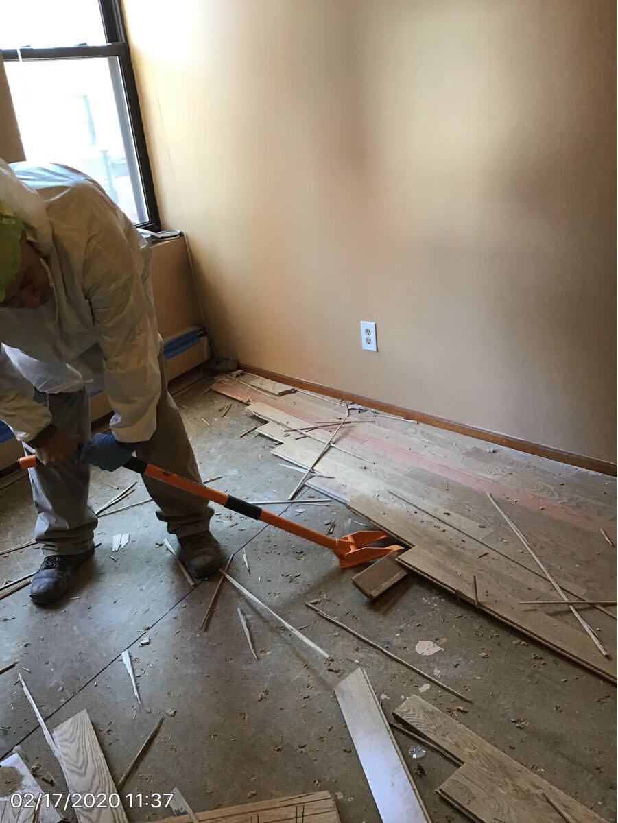 Removing the flooring in this Boston Barbershop was a must after a multi level leak.