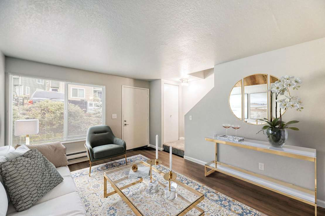 A living room with a couch and windows