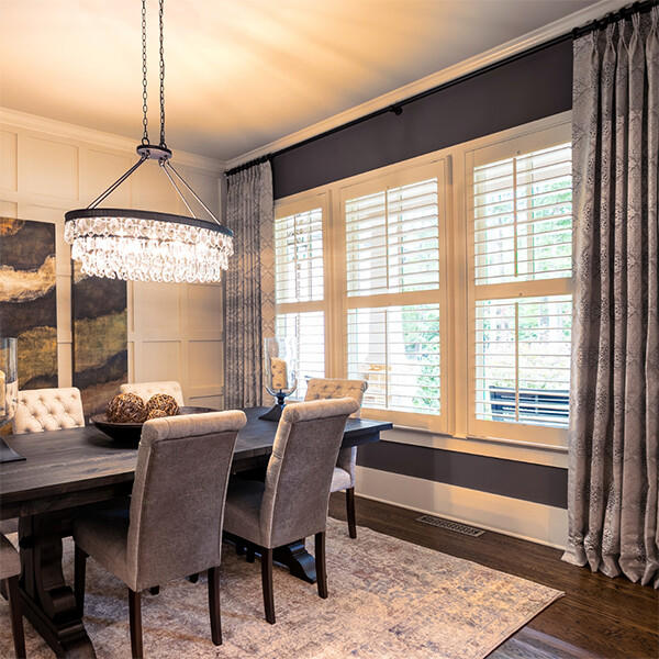 With 30 years of expertise, Budget Blinds knows how to make your house feel like a home.  This exquisite dining room combines our shutters and drapes to make an impeccable and stunning look. Our shutters are durable and help provide security while our drapes add height and dimension to the space.